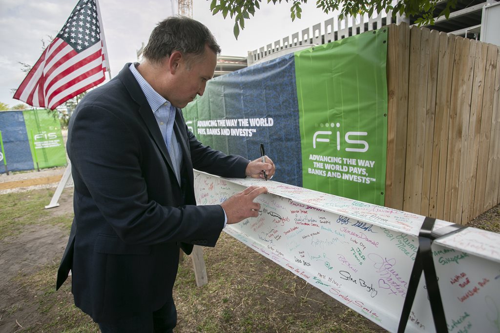 Image of Mayor Curry signing the FIS steel beam at the FIS topping off ceremony 