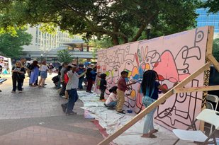 Photo of children painting a mural in Downtown's Hemming Park during Art Walk